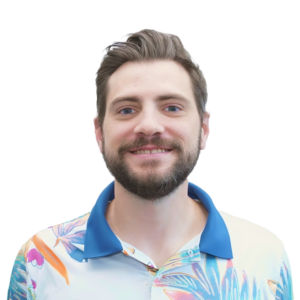 Portrait of a smiling man with beard wearing a light blue shirt,